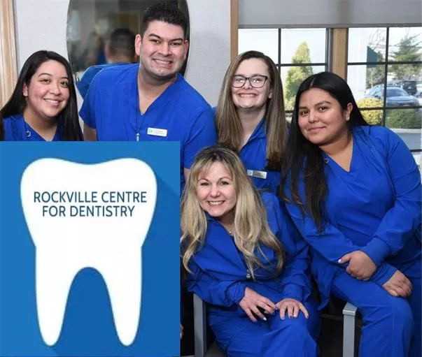 Dental team of five professionals in blue scrubs posing together at Rockville Centre for Dentistry clinic.