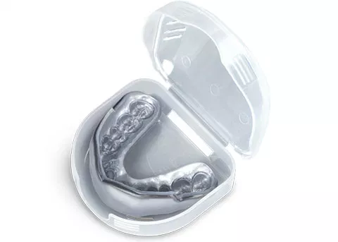 Clear plastic dental retainer case with silver retainer inside, displayed open.
